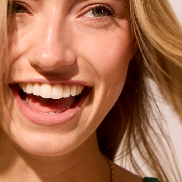 Close-up of womans face showing results of Acure cleansing gel